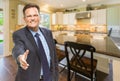 Male Agent Reaching for Hand Shake in New Kitchen