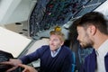 Male airport workers checking airplane