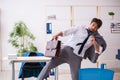 Young alcohol addicted employee sitting in the office