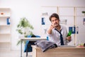 Young alcohol addicted employee sitting in the office