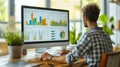Male analyst uses a laptop showing business analytics dashboard with charts, metrics, and KPI for operations management