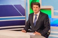 Male anchorman in tv studio. Live broadcasting Royalty Free Stock Photo