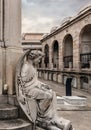 Male angel sculpture sitting at crypt in Poblenou Cemetery