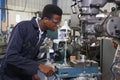 Male Apprentice Engineer Working On Drill In Factory Royalty Free Stock Photo