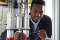 Male Apprentice Engineer Working On Machine In Factory Royalty Free Stock Photo