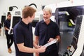 Male Apprentice Working With Engineer On CNC Machinery Royalty Free Stock Photo