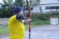 Male archer aiming at a mark on an archery shooting range