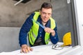 male architect with blueprint and ruler at office