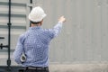 Male architect and blueprints with white helmet pointing finger on a construction site,Architects on construction site Royalty Free Stock Photo