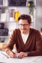 Male Architect At Desk In Office Amending Building Plans Royalty Free Stock Photo