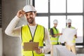 male architect in helmet with clipboard at office Royalty Free Stock Photo