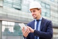 Male architect in helmet working at the tablet Royalty Free Stock Photo