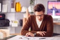 Male Architect In Office Working At Desk With Wooden Model Of Building Royalty Free Stock Photo