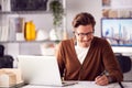 Male Architect In Office Working On Plan At Desk Taking Phone Call On Wireless Earphones Royalty Free Stock Photo