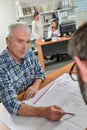 male architect pointing to plans Royalty Free Stock Photo