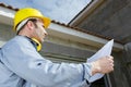 male architect on site looking at plans Royalty Free Stock Photo