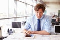 Male architect using tablet computer at a desk in an office Royalty Free Stock Photo