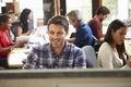 Male Architect Working At Desk With Meeting In Background Royalty Free Stock Photo