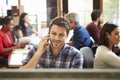 Male Architect Working At Desk With Meeting In Background Royalty Free Stock Photo