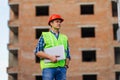 Male architects holding on laptop walking at construction site Royalty Free Stock Photo