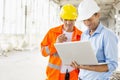 Male architects using laptop at construction site Royalty Free Stock Photo