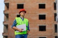 Male architects holding on laptop walking at construction site Royalty Free Stock Photo