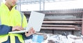 Male architecture using laptop at construction site