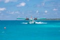 Male, Ari Atoll, Maldives - December 16. 2016: Seaplane of Trans Maldivian Airways landing in blue sea Royalty Free Stock Photo