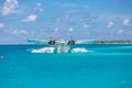 Male, Ari Atoll, Maldives - December 16. 2016: Seaplane of Trans Maldivian Airways landing in blue sea Royalty Free Stock Photo