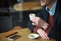 Male arm holding cup of beverage Royalty Free Stock Photo