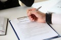 Male arm in office reading and signing employment contract form Royalty Free Stock Photo