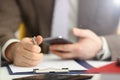 Male arm in suit hold phone and silver pen Royalty Free Stock Photo