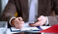 Male arm in suit hold phone and silver pen Royalty Free Stock Photo