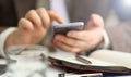 Male arm in suit hold phone and silver pen Royalty Free Stock Photo