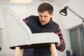 male artisan working on chair upholstery