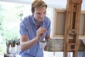 Male Artist Painting In Studio