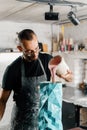 Male artist sculptor artisan creates a vase with his own hands in an art workshop