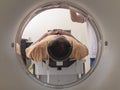 A male asian patient undergoes a CT scan at the clinic