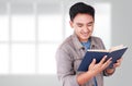 Male Asian Student Reading Book Royalty Free Stock Photo