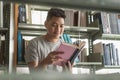 Male asian student studying and reading book in library Royalty Free Stock Photo