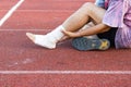 Male athlete applying compression bandage onto ankle injury