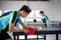 Male athlete carrying a ball and paddle while serving Royalty Free Stock Photo