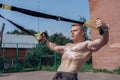 Male athlete close-up, trains nature city, summer trx training, Feel your strength and balance, motivation, tanned skin