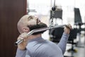 Male athlete doing exercises on pulldown machine in the gym, healthy lifestyle
