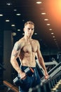 Male athlete with a dumbbell in the gym lean on Royalty Free Stock Photo