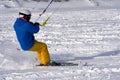 A male athlete engaged in snow kiting on the ice of a large snowy lake. He goes skiing in the snow.