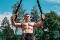 Male athlete is an excellent trx training, fresh air nature in summer, feel your strength and balance, motivation