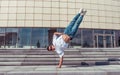 Male athlete, guy dancer summer city. Stand on one arm in air glasses. Fashionable modern break dance style fast Royalty Free Stock Photo