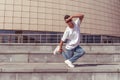 Male athlete, guy dancer summer city. Stand on one leg with glasses. Fashionable modern break dance style fast, fitness Royalty Free Stock Photo