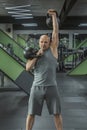 Male athlete lifts weights in the gym. Portret